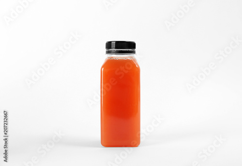 Bottle with delicious fresh juice on white background