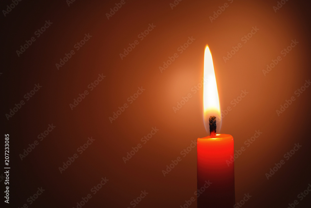Wax candle burning in darkness, closeup Wax candle burning in darkness, closeup