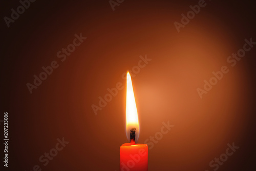 Wax candle burning in darkness, closeup