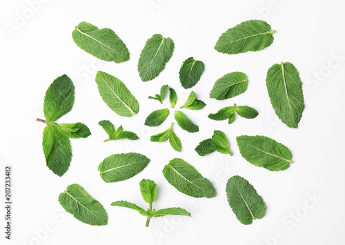 Flat lay composition with fresh green mint leaves on white background