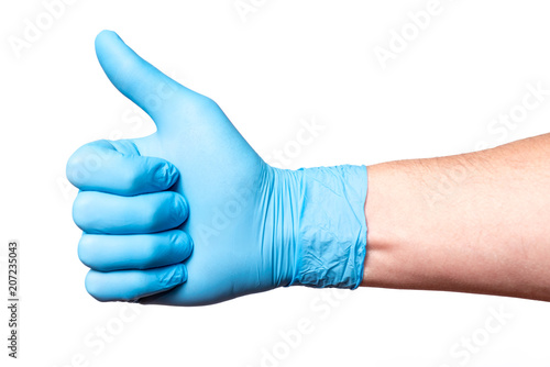 Hand in blue medical glove shows thumbs up