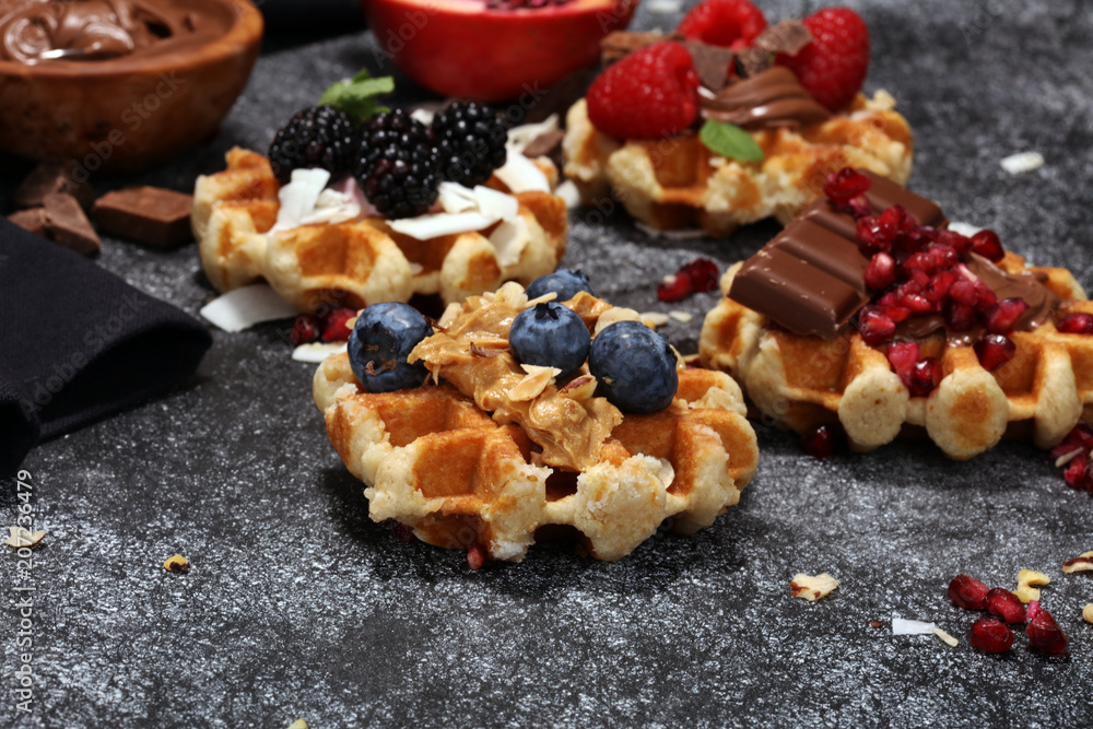 Belgian waffles with pomegranate and raspberries, homemade healthy breakfast with mint Belgian waffles with pomegranate and raspberries, homemade healthy breakfast with mint