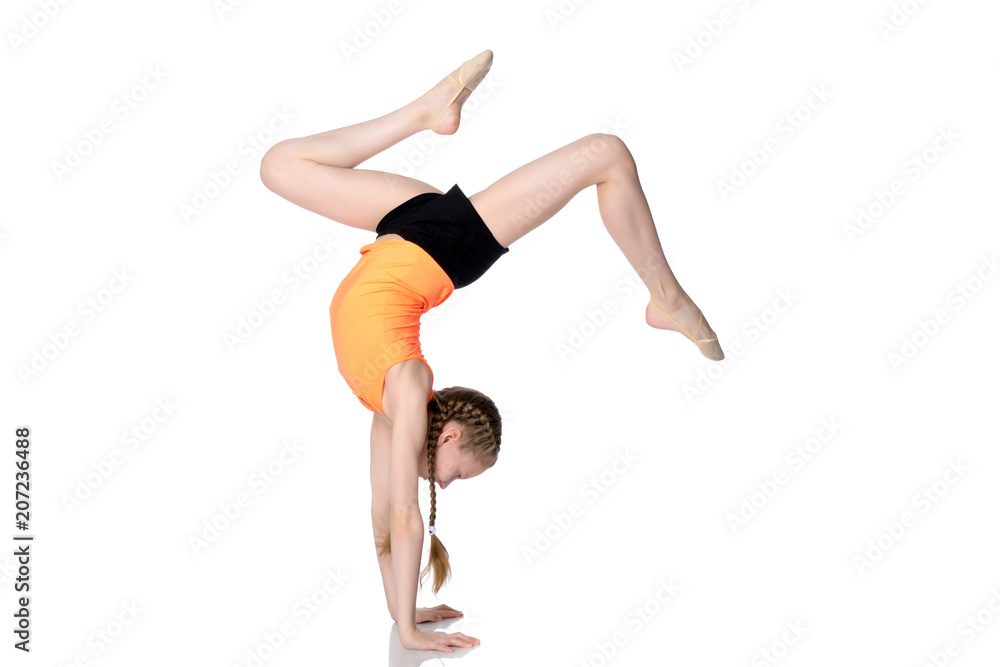 The gymnast performs a handstand with bent legs. The gymnast performs a handstand with bent legs.