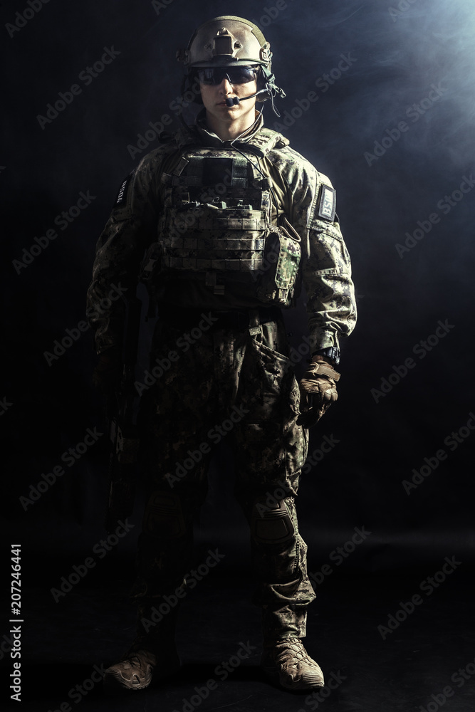 Special forces soldier with rifle on dark background Special forces soldier with rifle on dark background