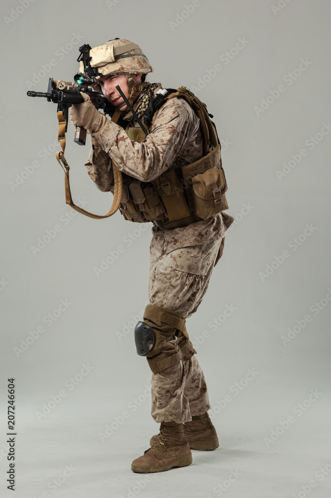Soldier in camouflage holding rifle Soldier in camouflage holding rifle