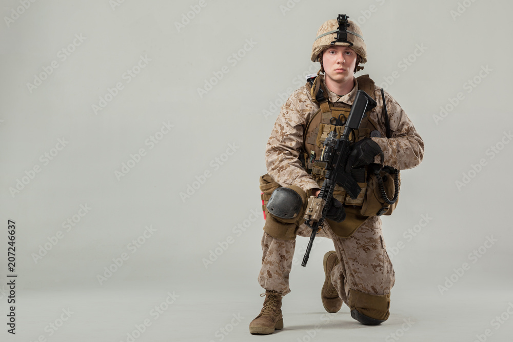 Soldier in camouflage holding rifle Soldier in camouflage holding rifle
