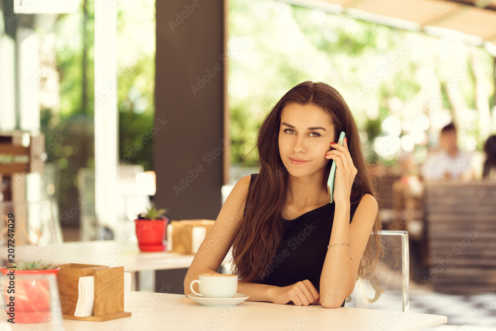 Woman Using Mobile Phone In cafe