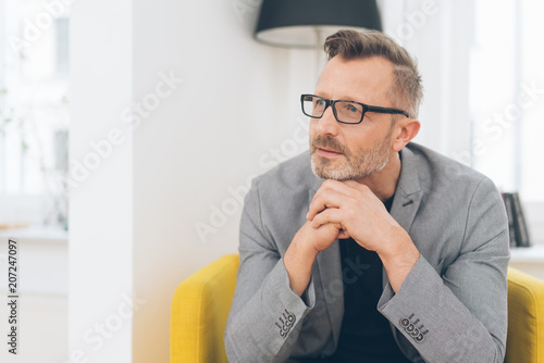 Photography Mature metro man gazing with hands under chin