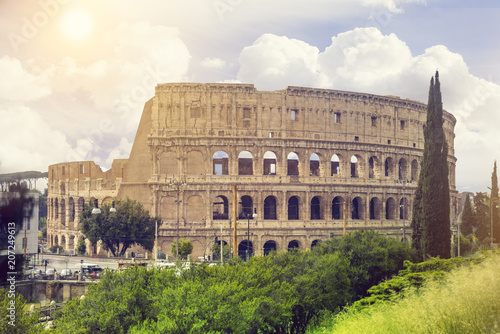 View of Colosseum in Rome and morning sun, Italy, Europe. Popular tourist attraction and landmark