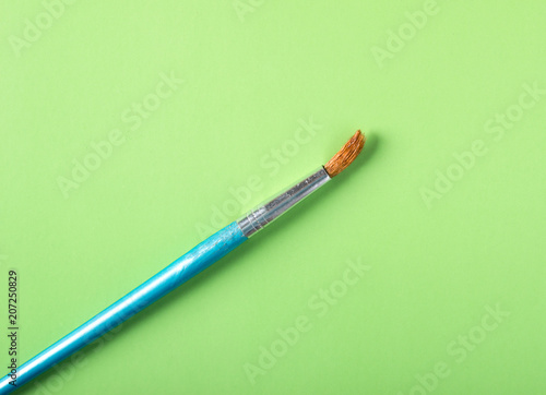 Paint brush on a colored background in pastel colors