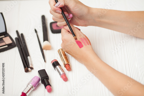 Tube of lipstick with a brush make-up on white background. Make up set  soft makeup brushes and maskara