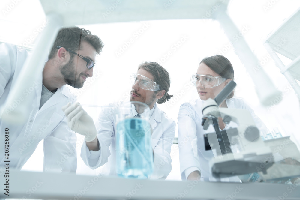 Group of scientists working on an experiment at the laboratory Group of scientists working on an experiment at the laboratory