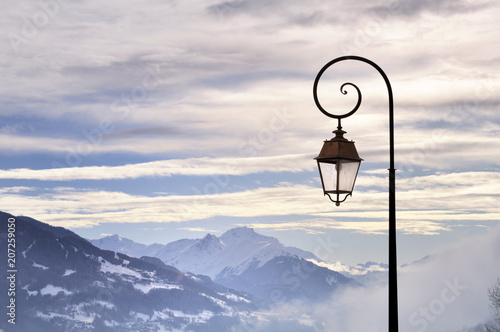 vintage streetlight on cloudy sky in a mountain village