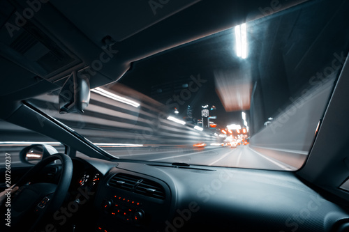 Car speed drive on the road in night city
