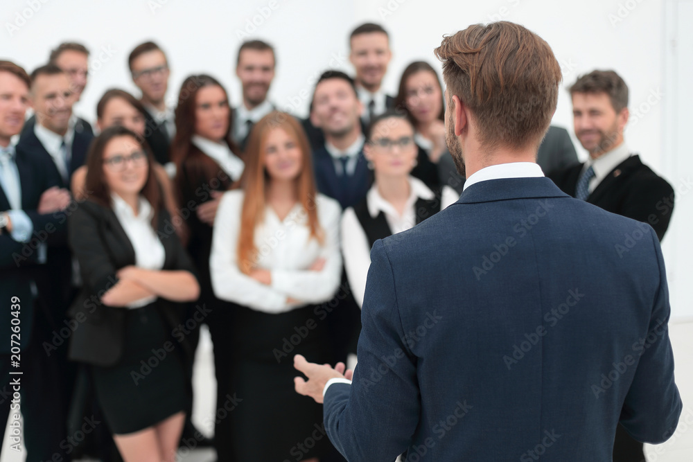 businessman makes a speech to his large business team businessman makes a speech to his large business team