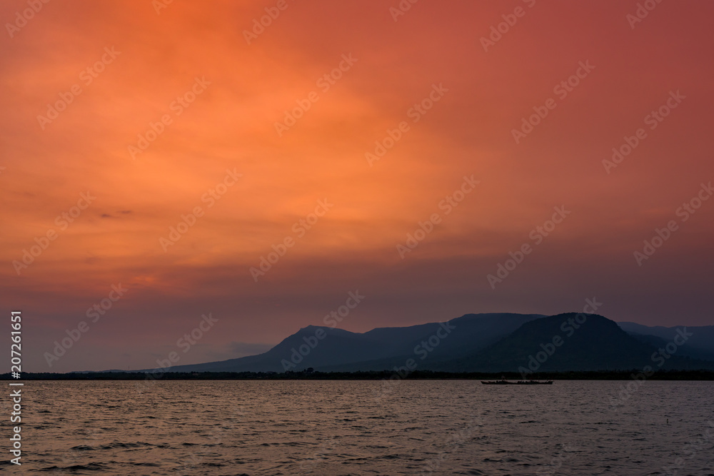 Sunset in Kampot sea coast with mountains in the background