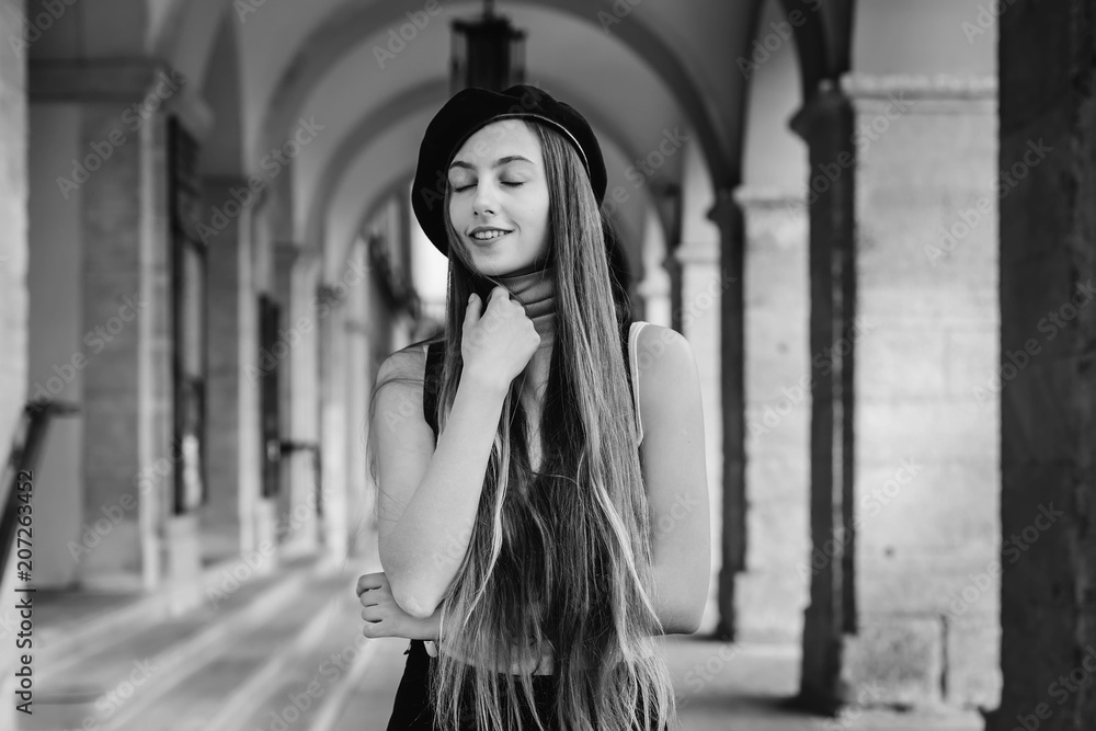 Obraz premium A charming girl with long and straight hair closed her eyes agai