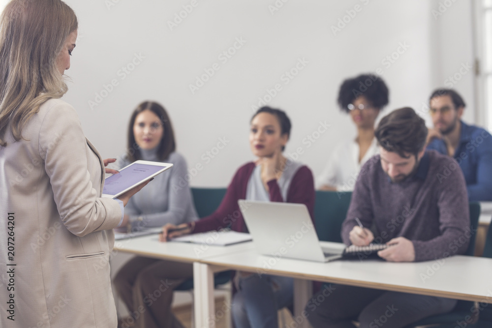 Businesswoman Presenting in Front of Audience Businesswoman Presenting in Front of Audience