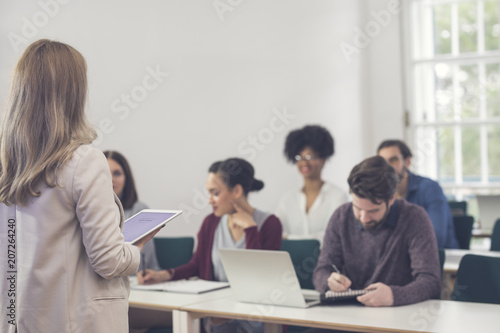 Businesswoman Presenting in Front of Audience