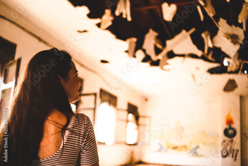 Young woman in decorated pavilion and destroyed roof photo