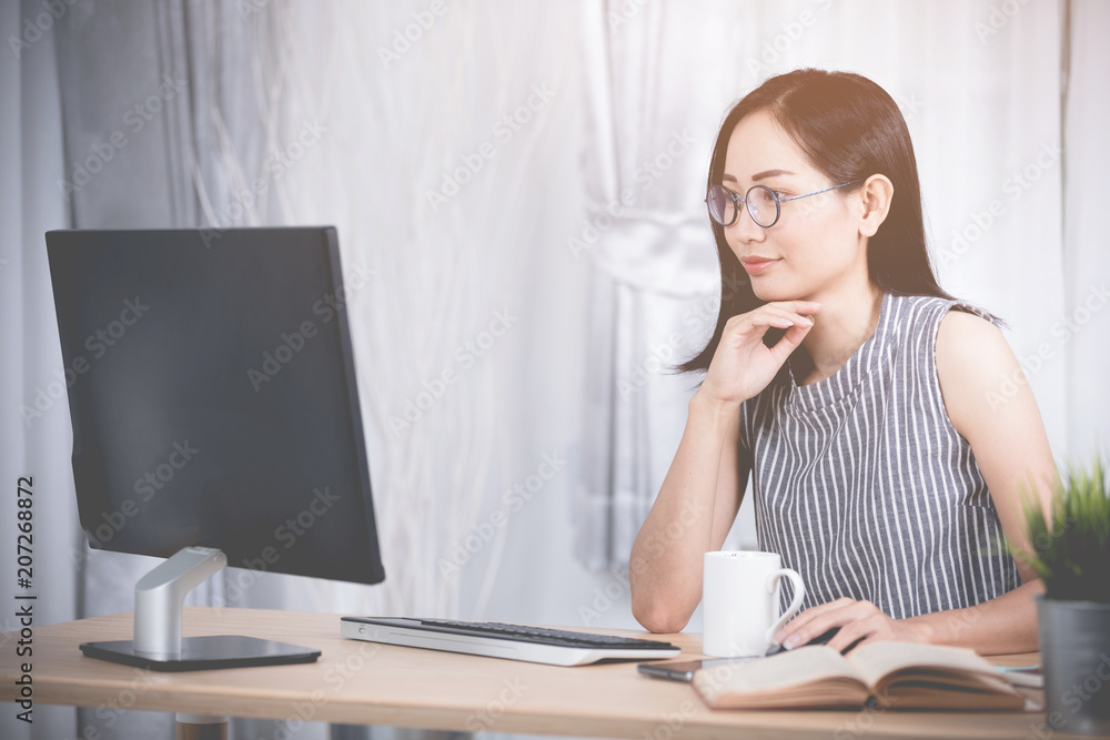 Young asian business woman working with compute .