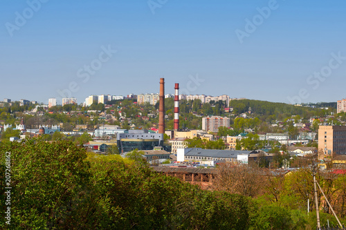 Factory pipes in the background of the summer city