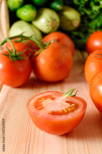 Close-up of fresh, ripe tomatoes on wooden background.