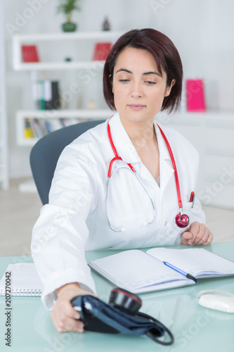 portrait of young female doctor in her office photo