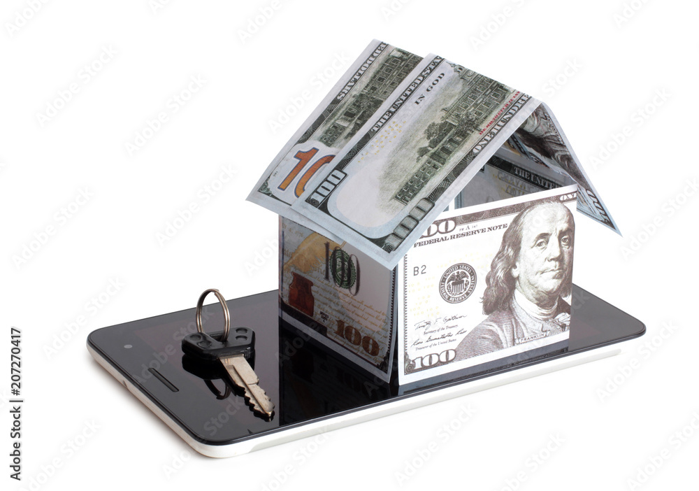 Paper house made of banknotes on a tablet on a white background Paper house made of banknotes on a tablet on a white background
