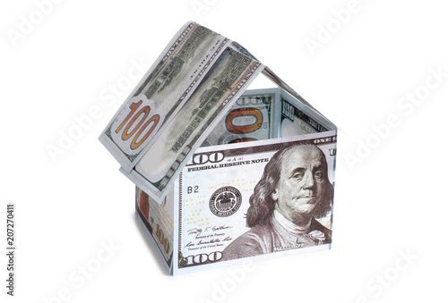 Paper house made of banknotes on white background