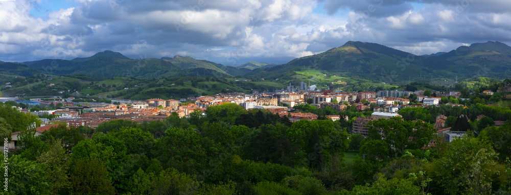 Scenic panoramic view of a village in mountain valley at sunset. Colourful countryside landscape with mountain, Hernani Basque Country
