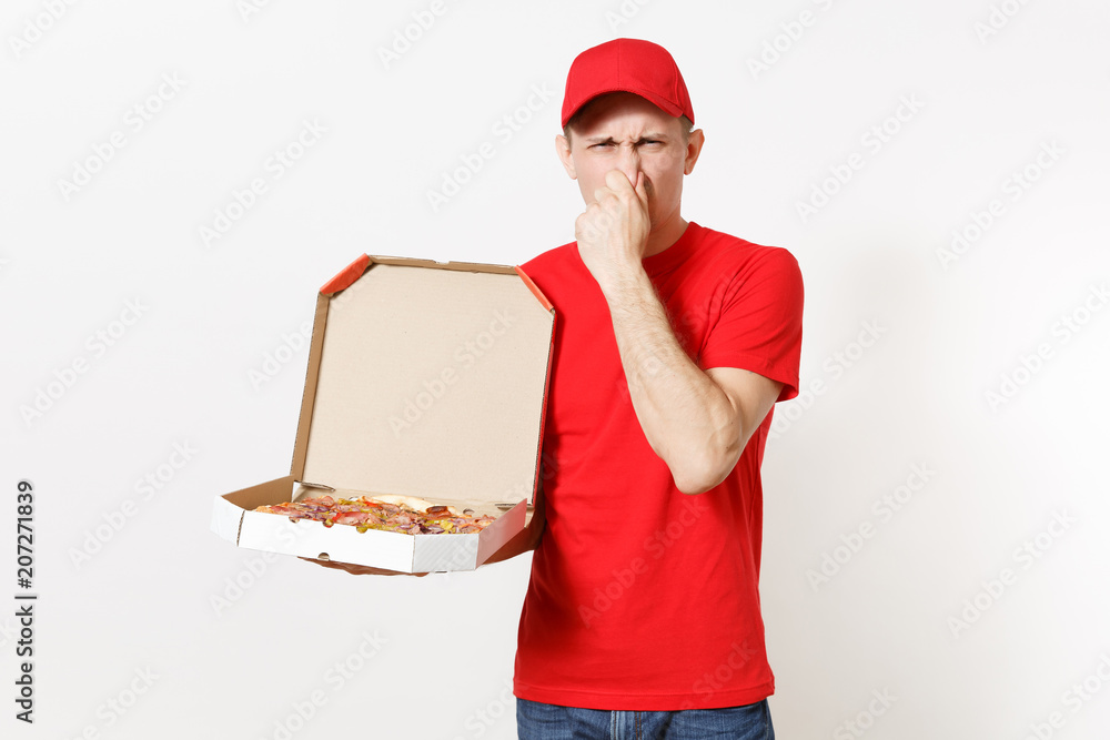 Delivery shocked man in red uniform isolated on white background. Male pizzaman in cap, t-shirt working as courier or dealer holding italian pizza in cardboard flatbox. Copy space for advertisement. Delivery shocked man in red uniform isolated on white background. Male pizzaman in cap, t-shirt working as courier or dealer holding italian pizza in cardboard flatbox. Copy space for advertisement.