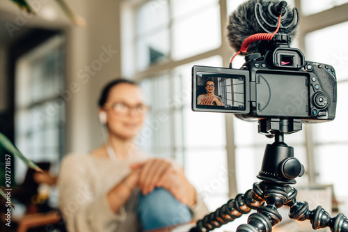Woman blogger recording her content on camera photo