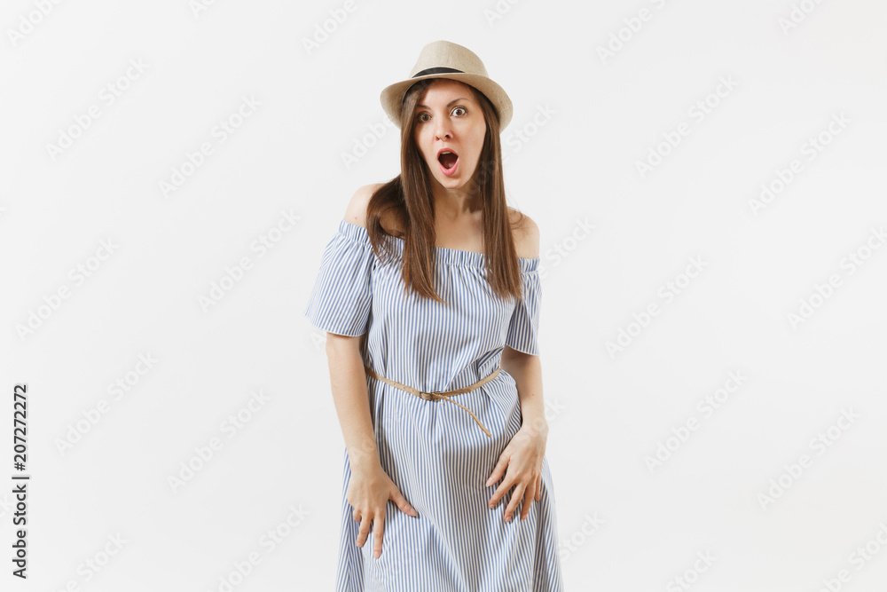 Young tender elegant woman in blue dress, hat keeping mouth wide open, looking surprised, posing isolated on white background. People, sincere emotions, lifestyle concept. Advertising area. Copy space Young tender elegant woman in blue dress, hat keeping mouth wide open, looking surprised, posing isolated on white background. People, sincere emotions, lifestyle concept. Advertising area. Copy space