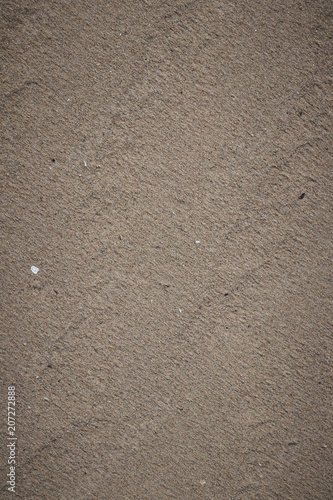 Closeup of sand pattern of a beach .