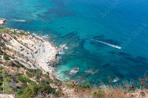 View from above on a rocky coastline, turquoise ocean, holiday, summer day.