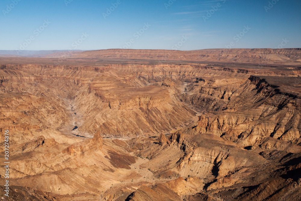 Horseshoe bend in Fish River Canyon on hot sunny day, Namibia. Horseshoe bend in Fish River Canyon on hot sunny day, Namibia.