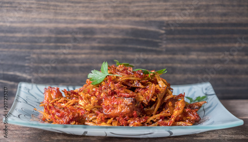 Malay dish stir fried chili with deep fried anchovies and potato cubes or locally known as ikan bilis goreng berlada. photo