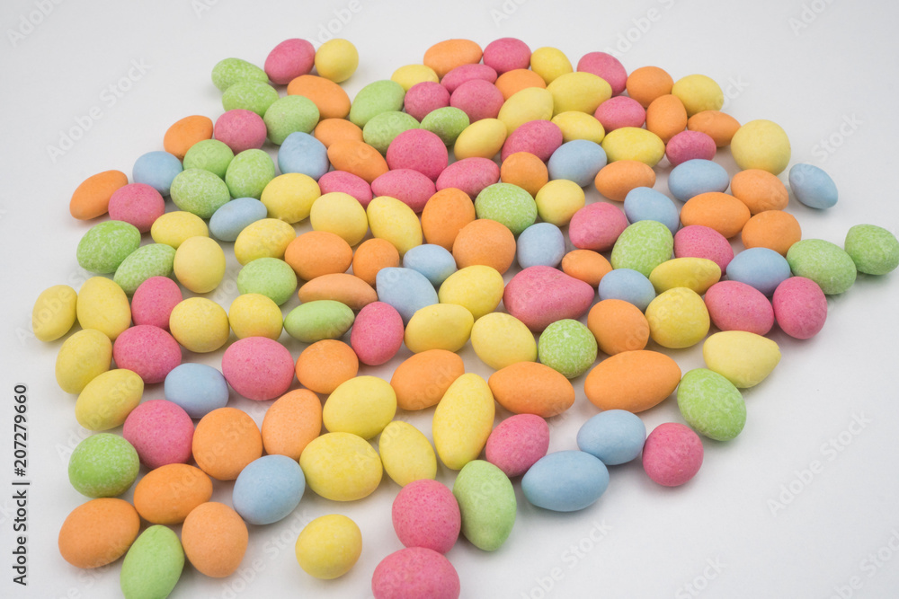 Small colorful chocolate candies on a white background Small colorful chocolate candies on a white background