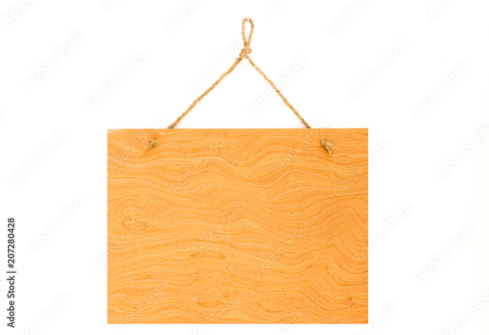 The symbol, made of natural wood with a rope, hangs on a white b The symbol, made of natural wood with a rope, hangs on a white b