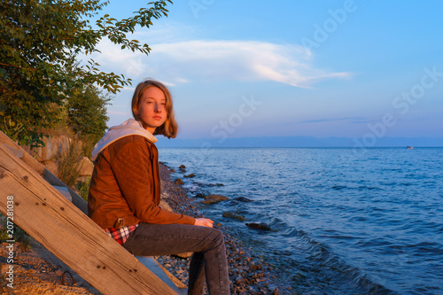 Portrait of young beautiful lady admiring the summer landscape o