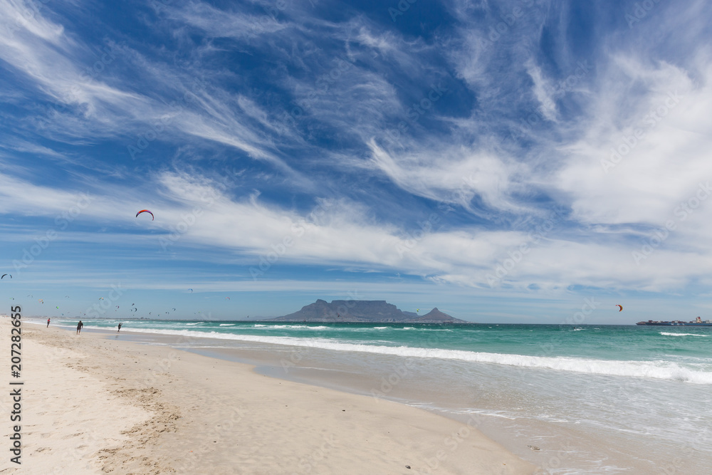 View of Table Mountain from Blouberg in Cape Town with wind surfers