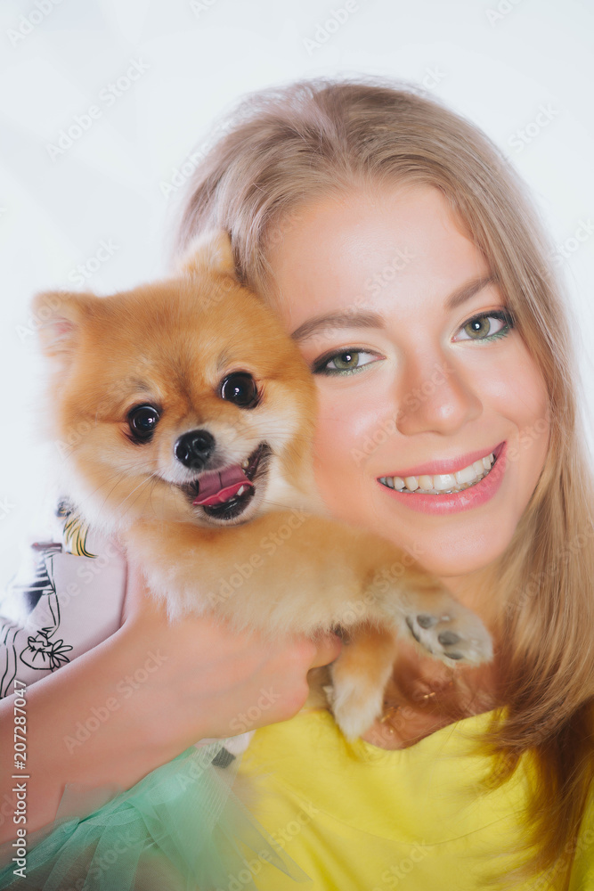 love of dogs. Beautiful young woman is holding a puppy on her hands.a girl is holding a dog.National pet's day. A young woman is holding a puppy in her hands. Buying a dog. Happiness. To love animals. love of dogs. Beautiful young woman is holding a puppy on her hands.a girl is holding a dog.National pet's day. A young woman is holding a puppy in her hands. Buying a dog. Happiness. To love animals.