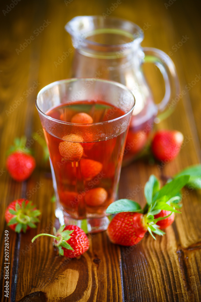 Sweet compote of ripe red strawberries in a glass decanter Sweet compote of ripe red strawberries in a glass decanter
