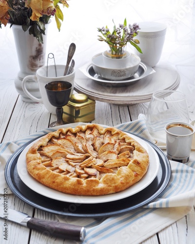 On the table on a white plate of galette with apples