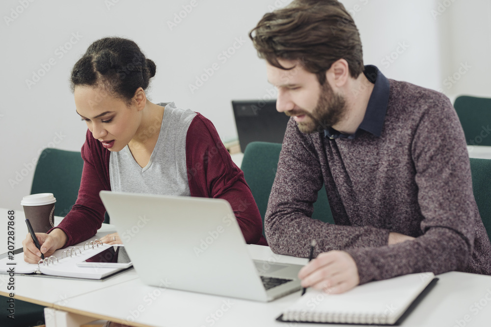 Man and Woman Working Together in Office Man and Woman Working Together in Office