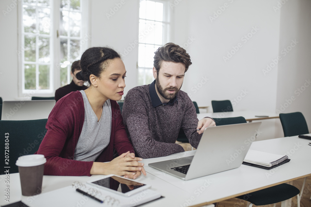 Man and Woman Working Together in Office Man and Woman Working Together in Office