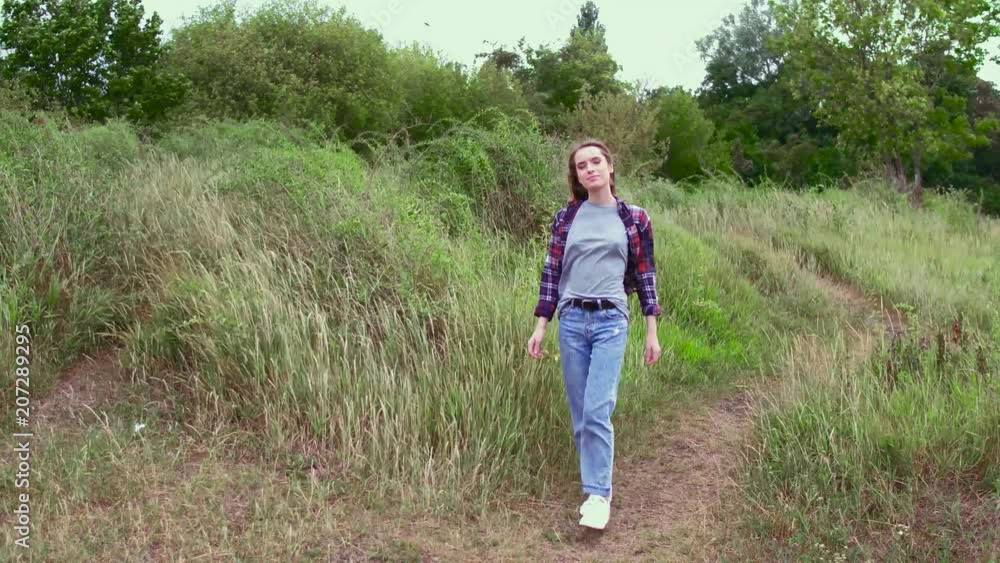 Happy girl in fashion clothes walking on field path. Nature concept. Happy girl in fashion clothes walking on field path. Nature concept.