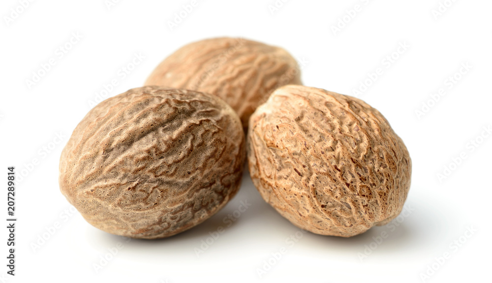 closeup of nutmeg spice isolated on white closeup of nutmeg spice isolated on white