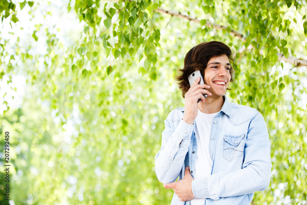 Young man talking on phone while standing outdoor Young man talking on phone while standing outdoor